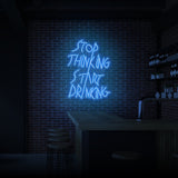 "STOP THINKING START DRINKING" NEON SKILT