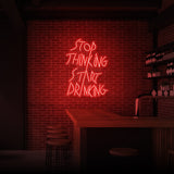 "STOP THINKING START DRINKING" NEON SKILT